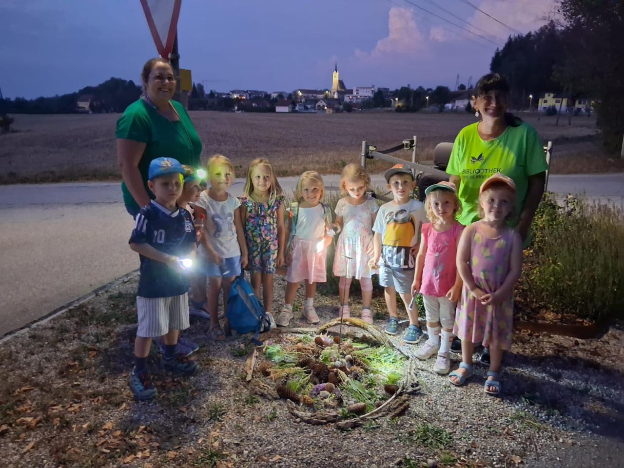 Gruppenbild Kinder vor einem Naturmandala