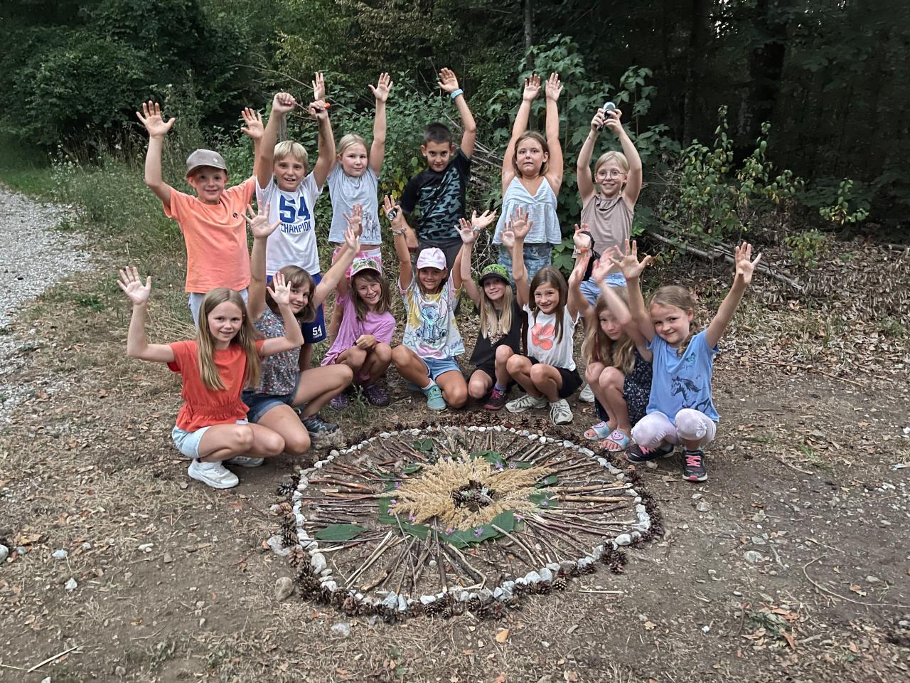 Gruppenbild von Kindern hinter einem Naturmandala